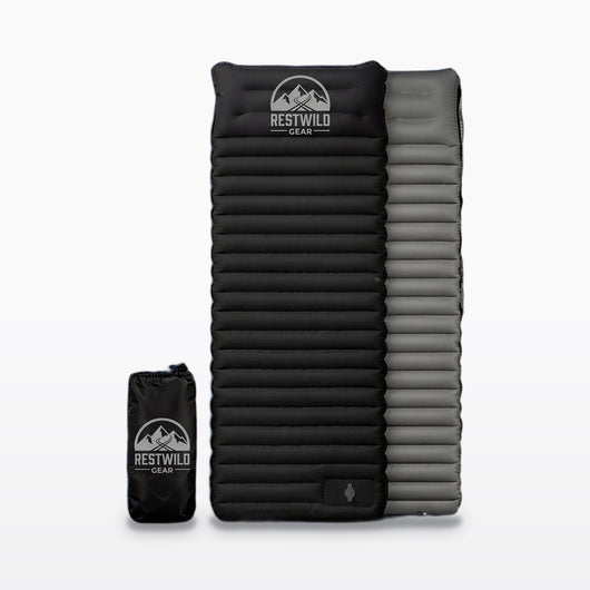 Black Restwild Mattress Pro V2 sleeping pad with its gray underside and black stuff sack