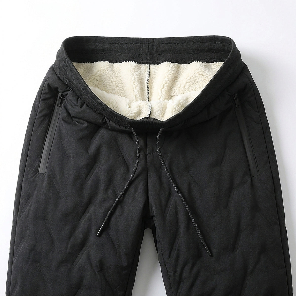 Waistband of the black winter pants folded open: cream sherpa fleece lining, drawcord and two zippered side pockets