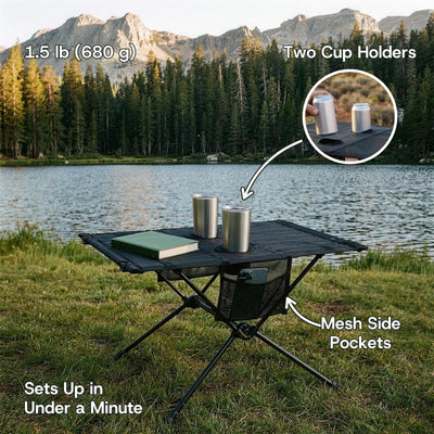 Folding camping table by a mountain lake with two tumblers in the cup holders and a phone in the mesh pocket. 1.5 lb (680 g)